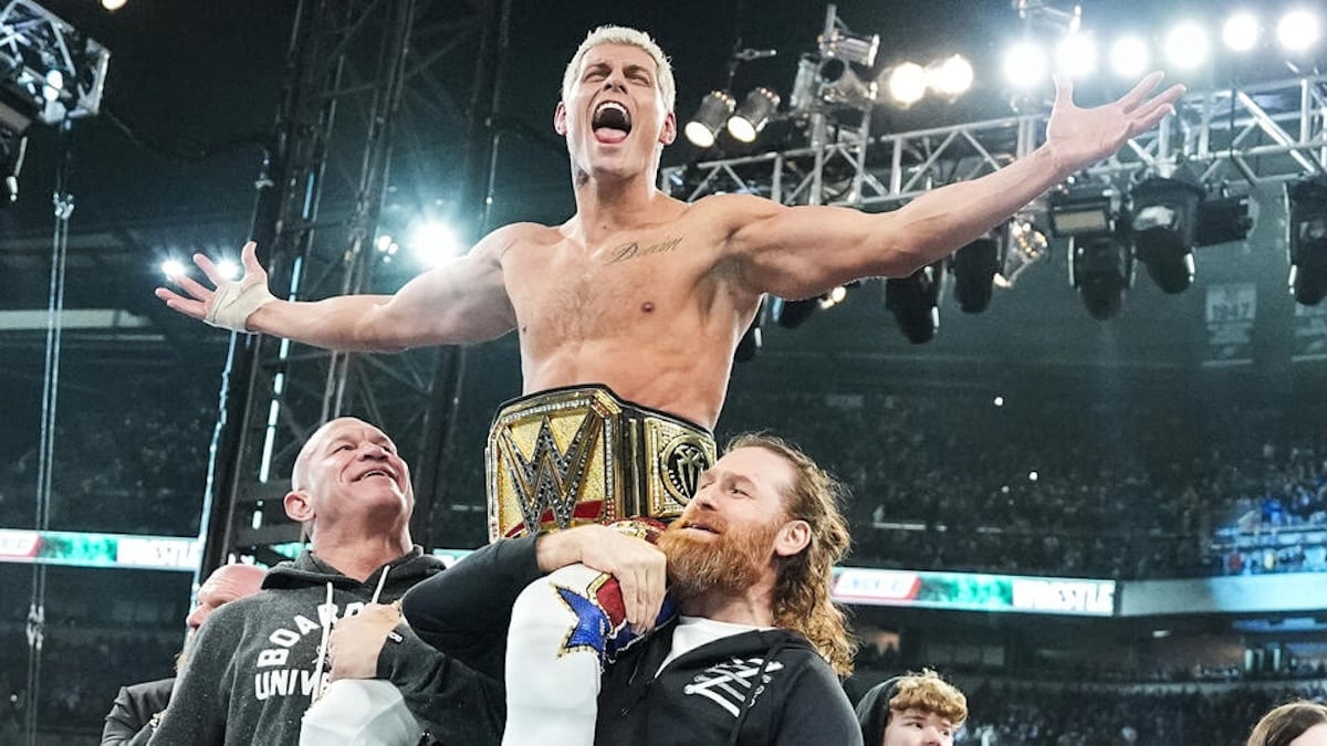 Cody Rhodes sitting on the shoulders of men holding him up after Wrestlemania