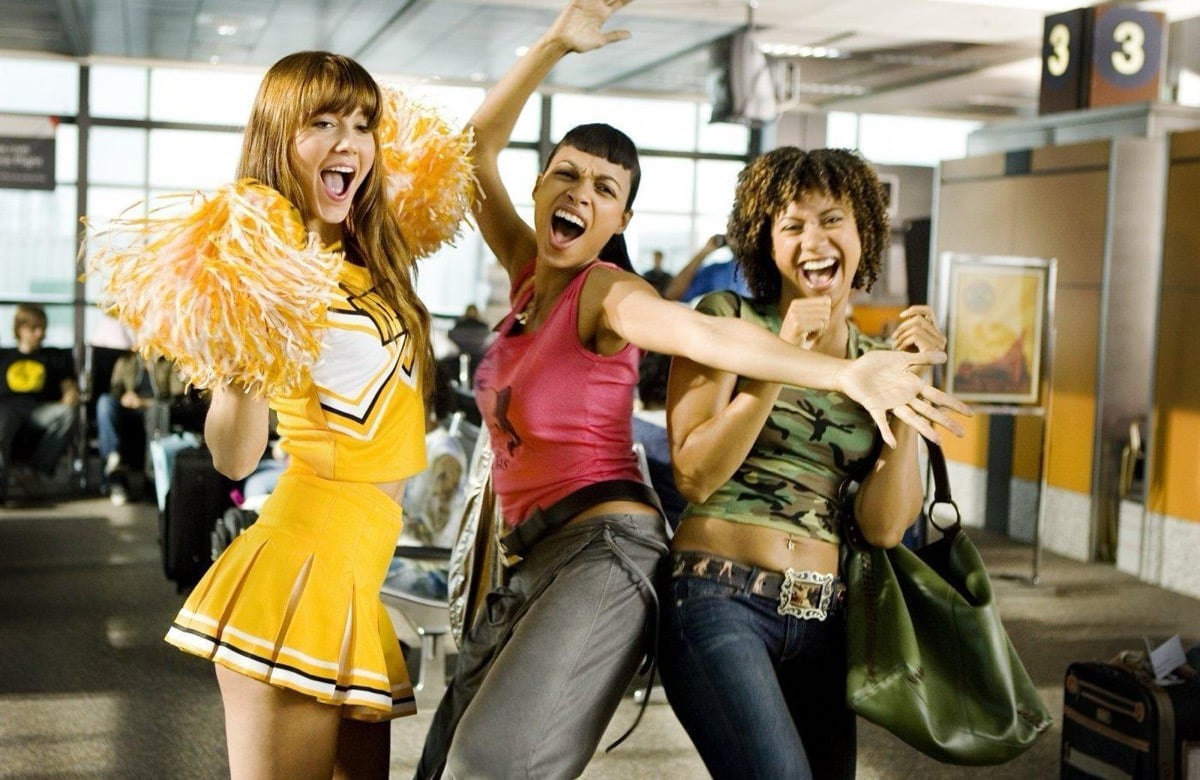 Three women - one dressed as a cheerleader - dance around in a store in "Death Proof"