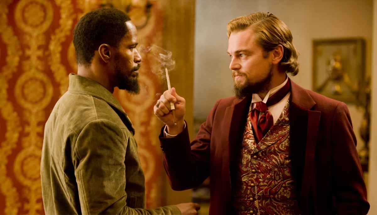 An affluent slaveowner waves a cigarette in a bounty hunter's face in "Django Unchained" 