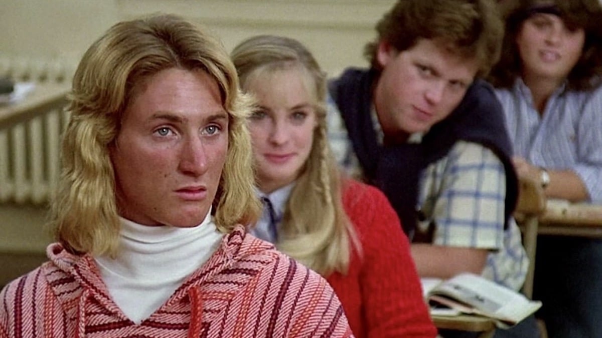 A surfer dude sits at a classroom desk looking confused in "Fast Times at Ridgemont High" 