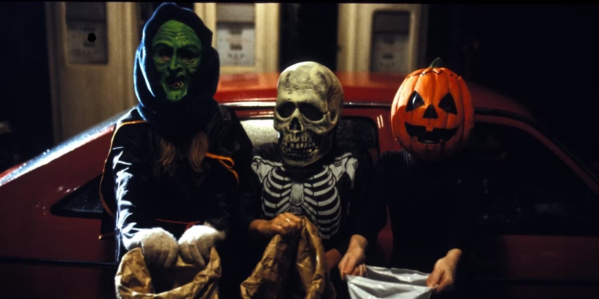 Three kids sit on the couch wearing Halloween costumes in "Halloween 3: Season of the Witch" 