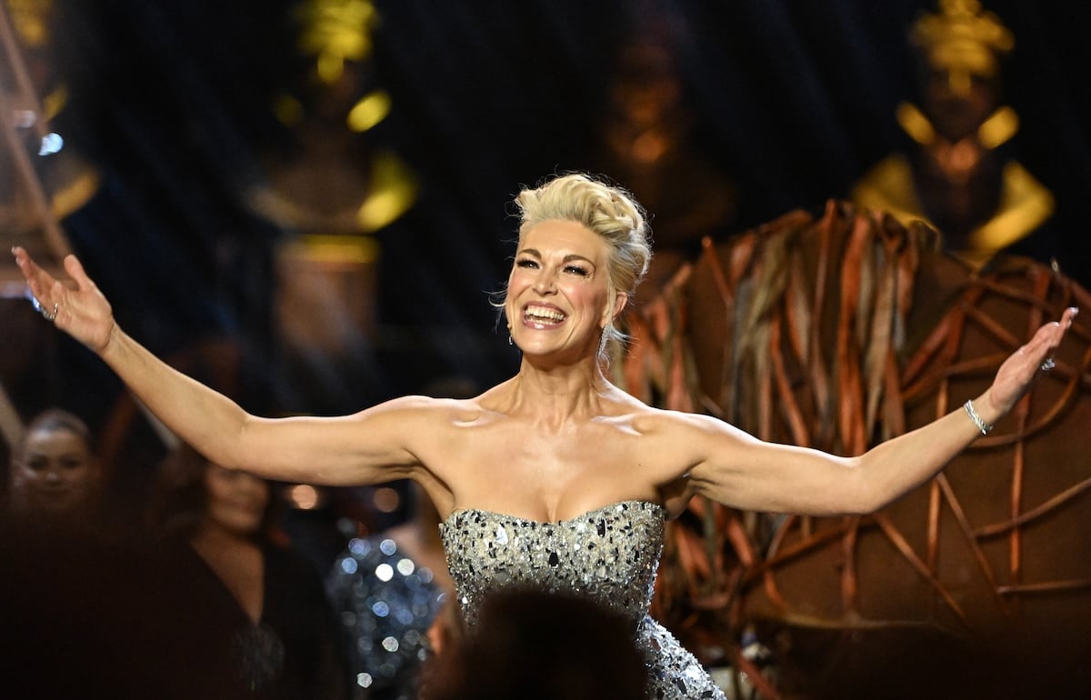 Hannah Waddingham with her arms raised while on stage