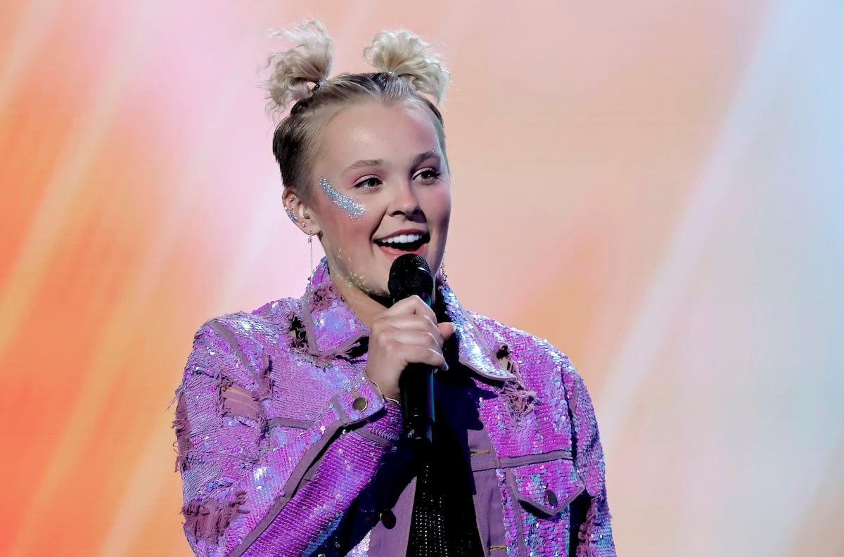 JoJo Siwa with a mic in her hand on stage