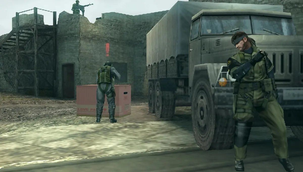 Big Boss hides from a soldier behind a truck in "Metal Gear Solid: Peace Walker"