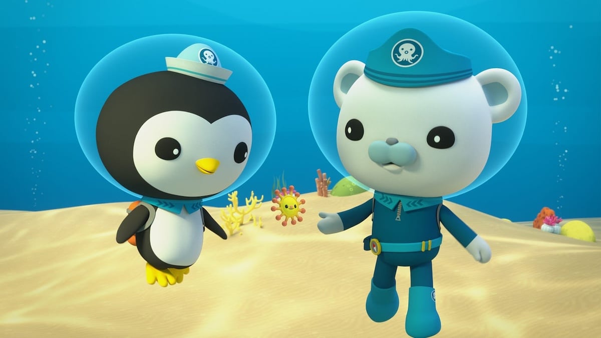 Two Octonauts wearing diving suits in the ocean.