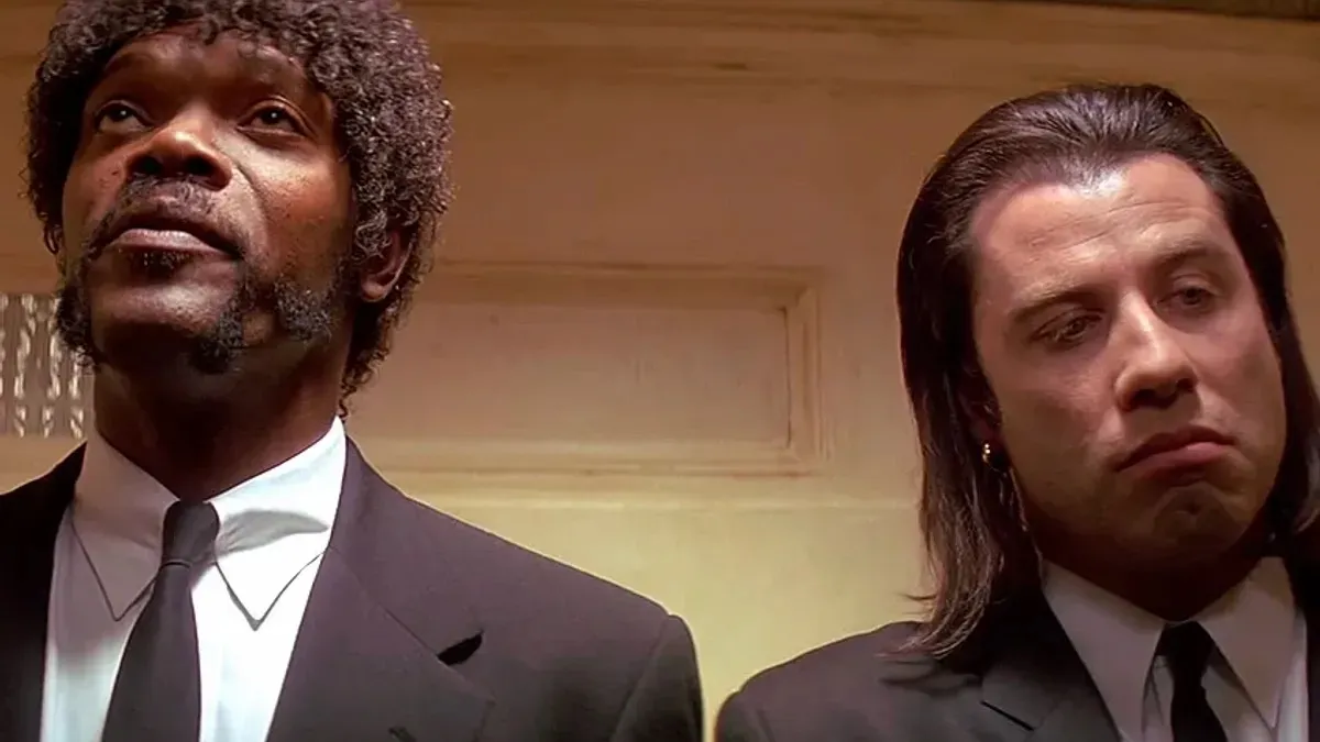 Two suit clad assassins stand in a hallway in "Pulp Fiction" 