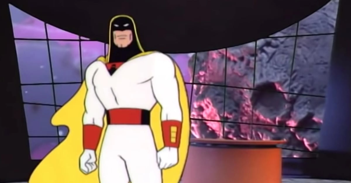A man in a white and black superhero costume stands in front of a talk show desk with a meteor in the background. From Space Ghost: Coast to Coast.