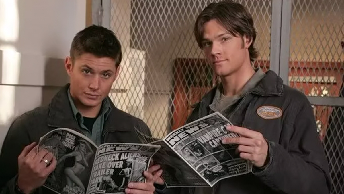 sam and dean holding a news paper