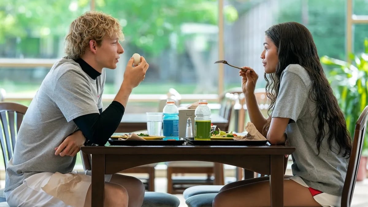 Zendaya and Mike Faist sitting at a table eating in Challengers