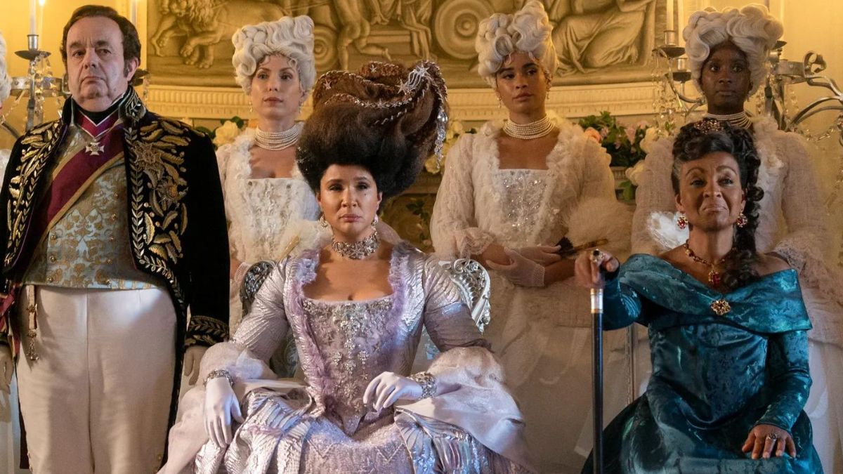 Queen Charlotte, Lady Danbury and Brimsely looking over the couples dancing at the ball in episode 2 of Bridgerton season 3