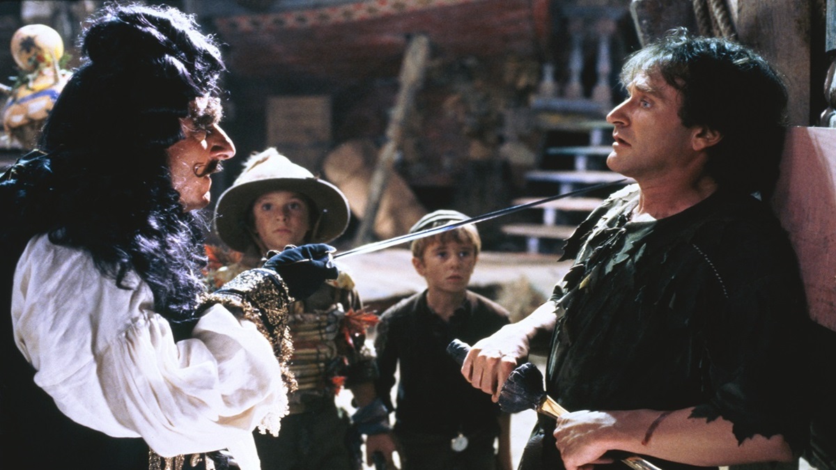 Dustin Hoffman as Captain Hook holds Peter Pan (Robin Williams) hostage