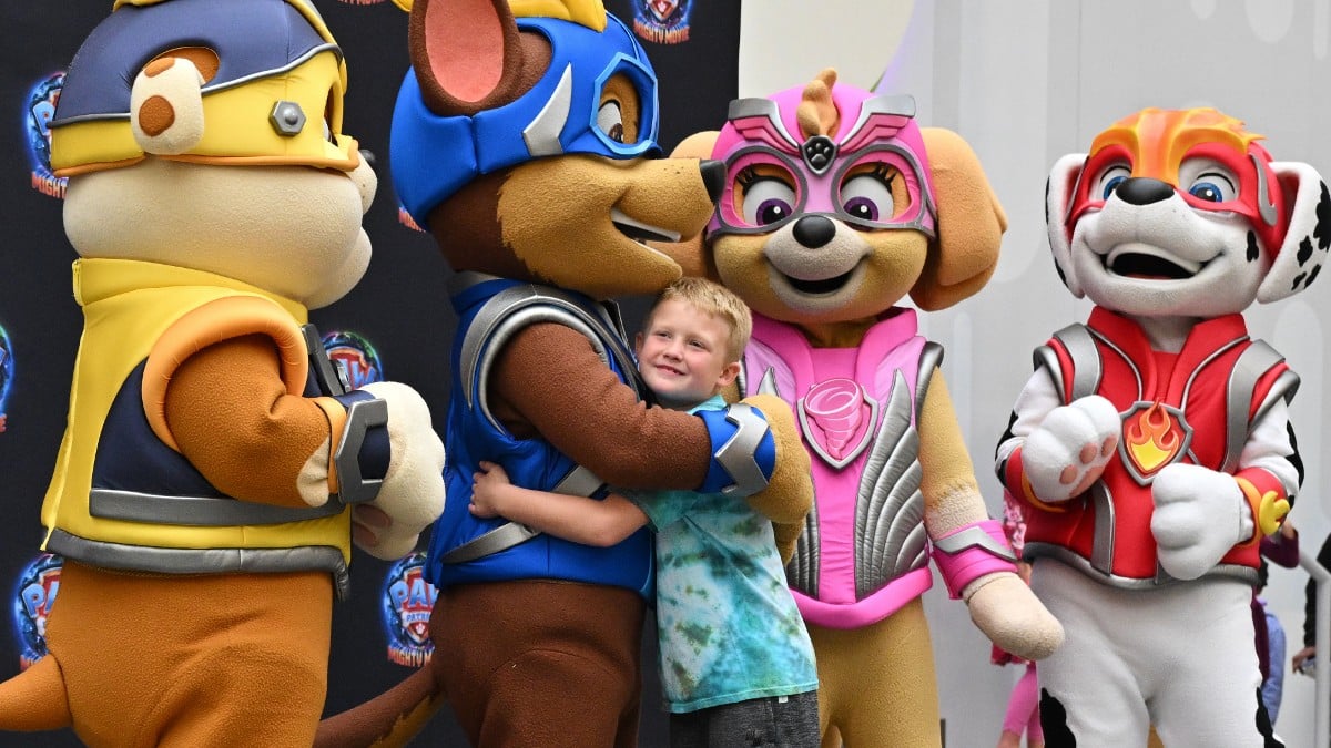 Actors in Paw Patrol characters pose with children at American Dream