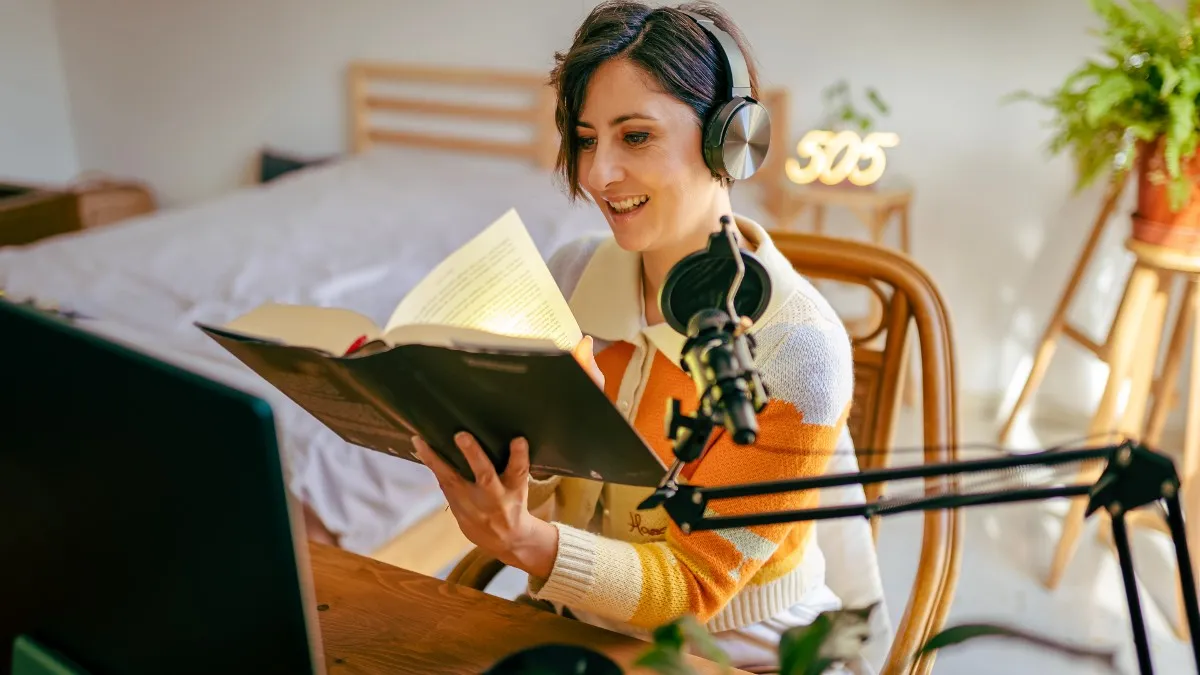 A woman records herself reading a book