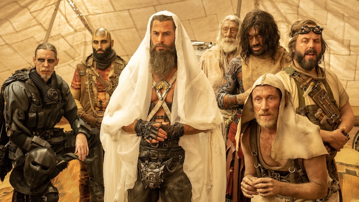 Dementus (Chris Hemsworth) stands in a tent surrounded by other gang members.