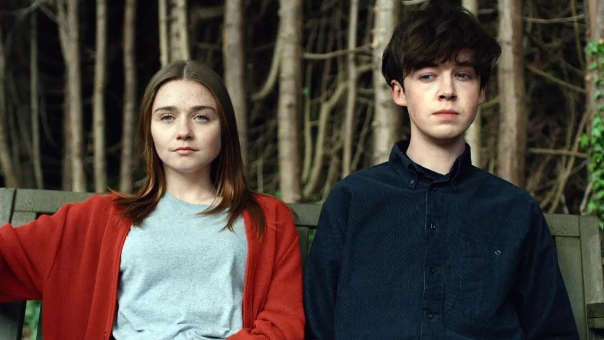 the cast of end of the f***ing world sitting on a bench together