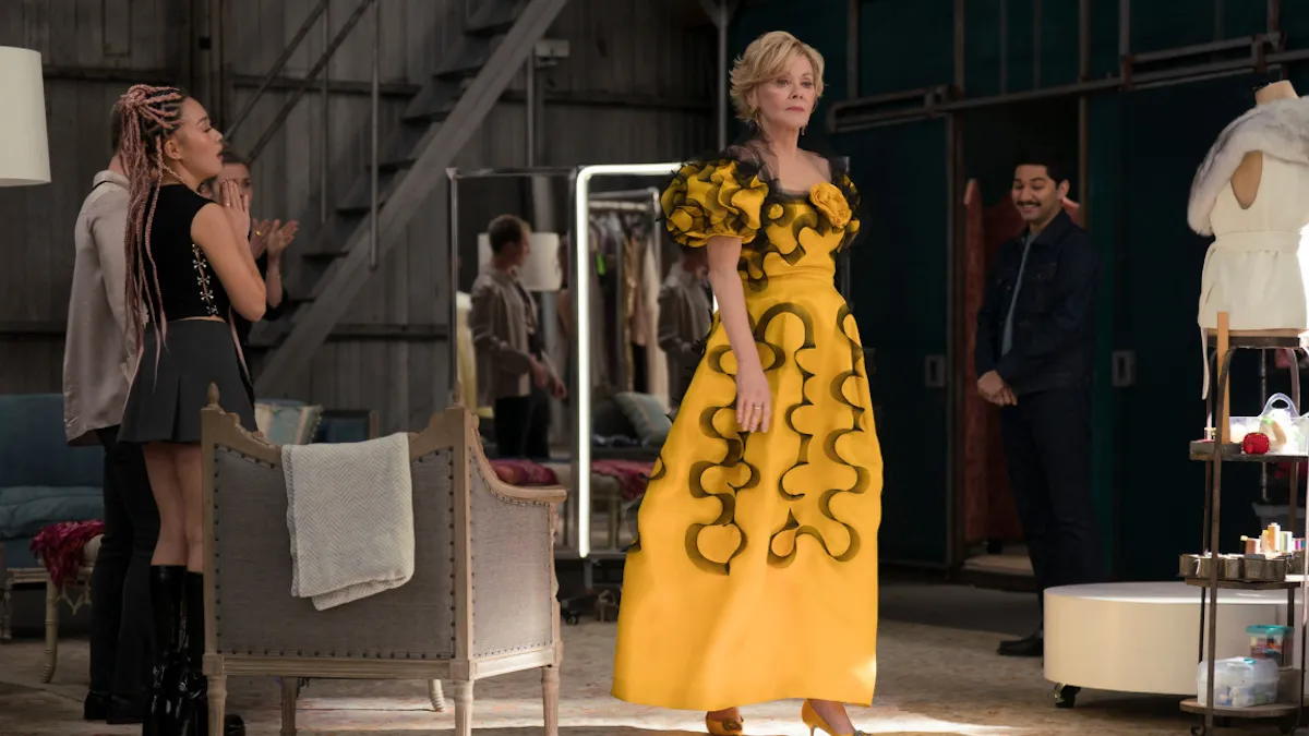 Deborah Vance shows off a yellow ball gown with black ruffles on it.