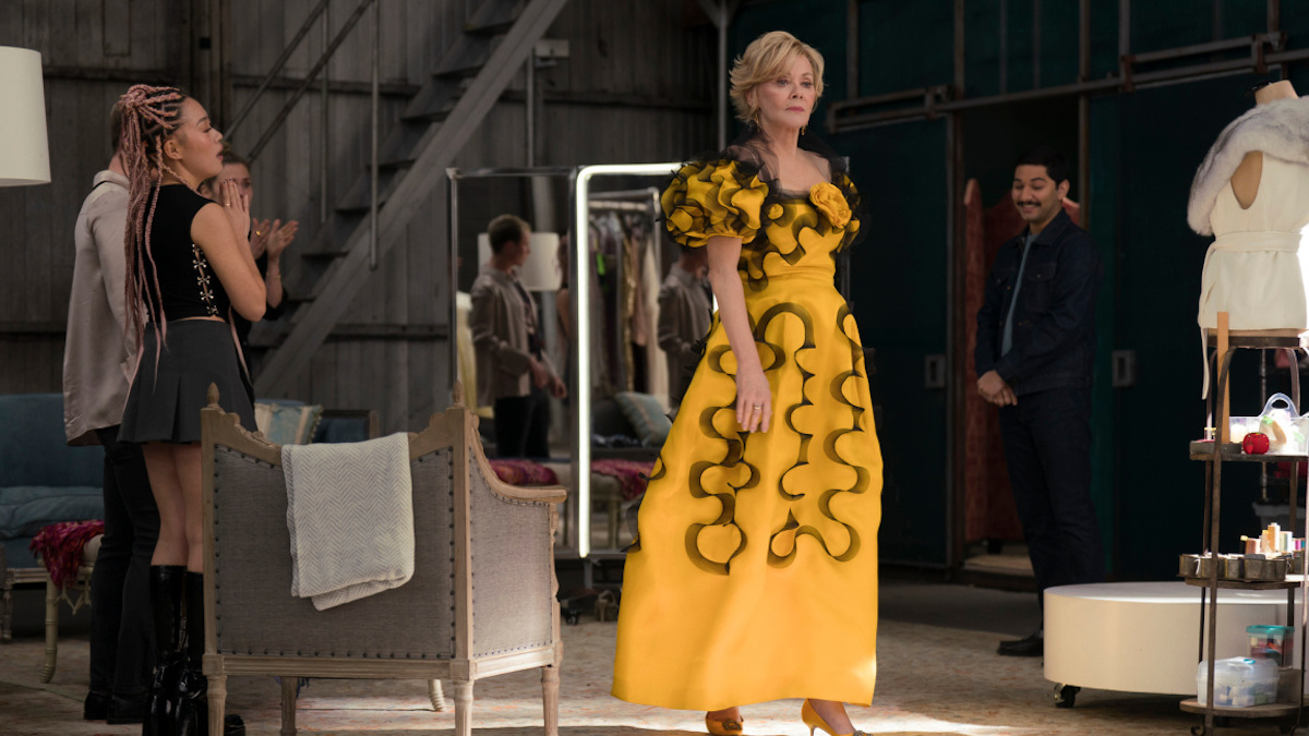 Deborah Vance shows off a yellow ball gown with black ruffles on it.
