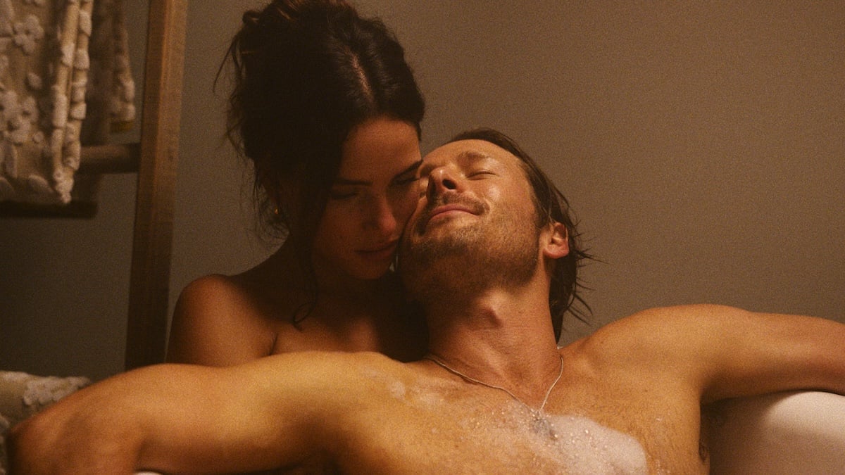 Glen Powell and Adria Arjona in a bathrub together in Hit Man