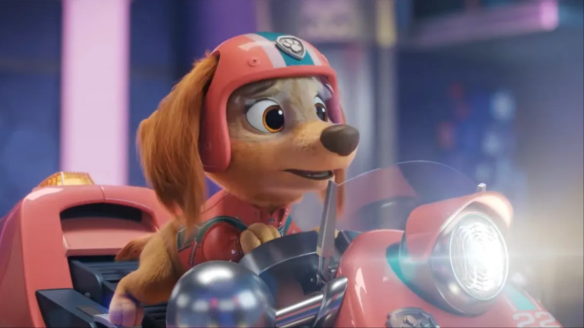 Liberty the longhaired dashshund rides a pink scooter in 'Paw Patrol: The Movie'.