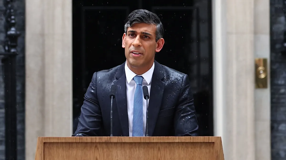 UK Prime Minister Rishi Sunak is rained upon while making general election announcement.