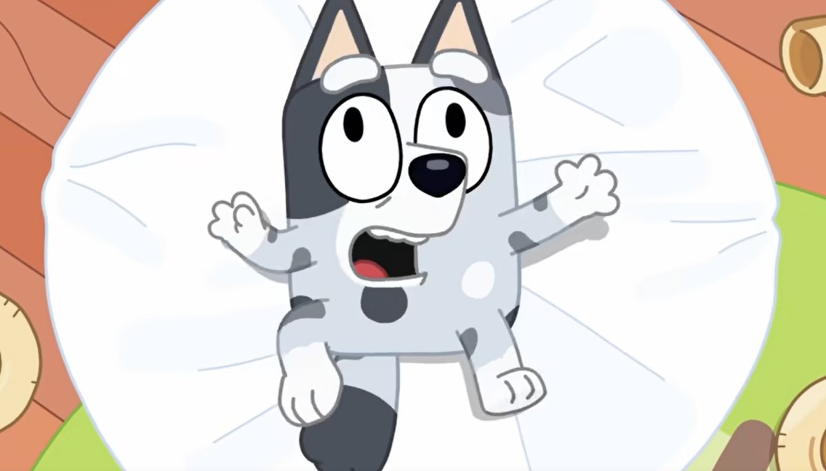 Muffin rolling about on top of a white table