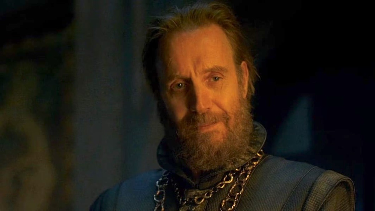 Otto Hightower smiles in the firelight in "House of the Dragon"