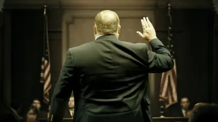 Alex Jones raises his right hand to take an oath in court in 