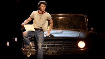 The Outsiders Brody Grant on a car