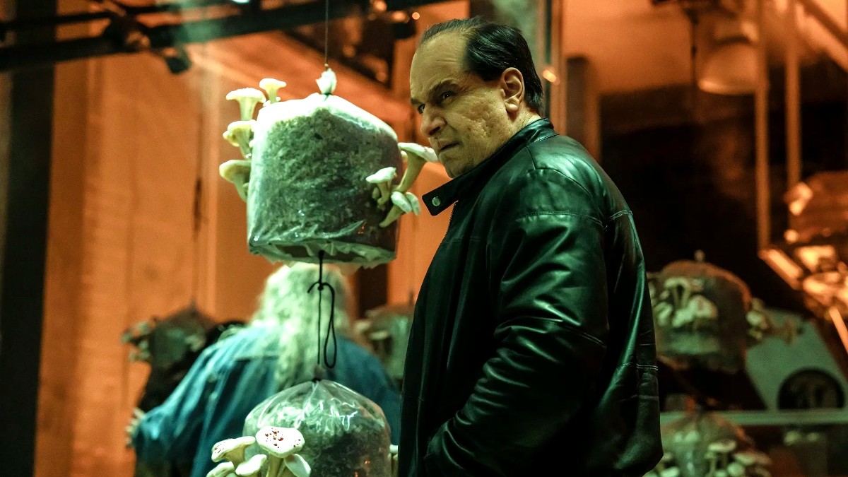 Colin Farrell as Oswald Cobb standing next to mushrooms in The Penguin