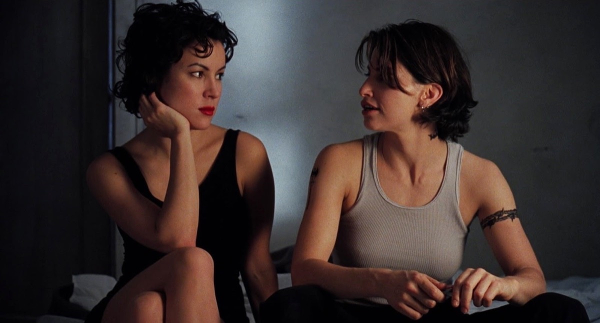 Two beautiful women make eyes at each other while sitting in "Bound"