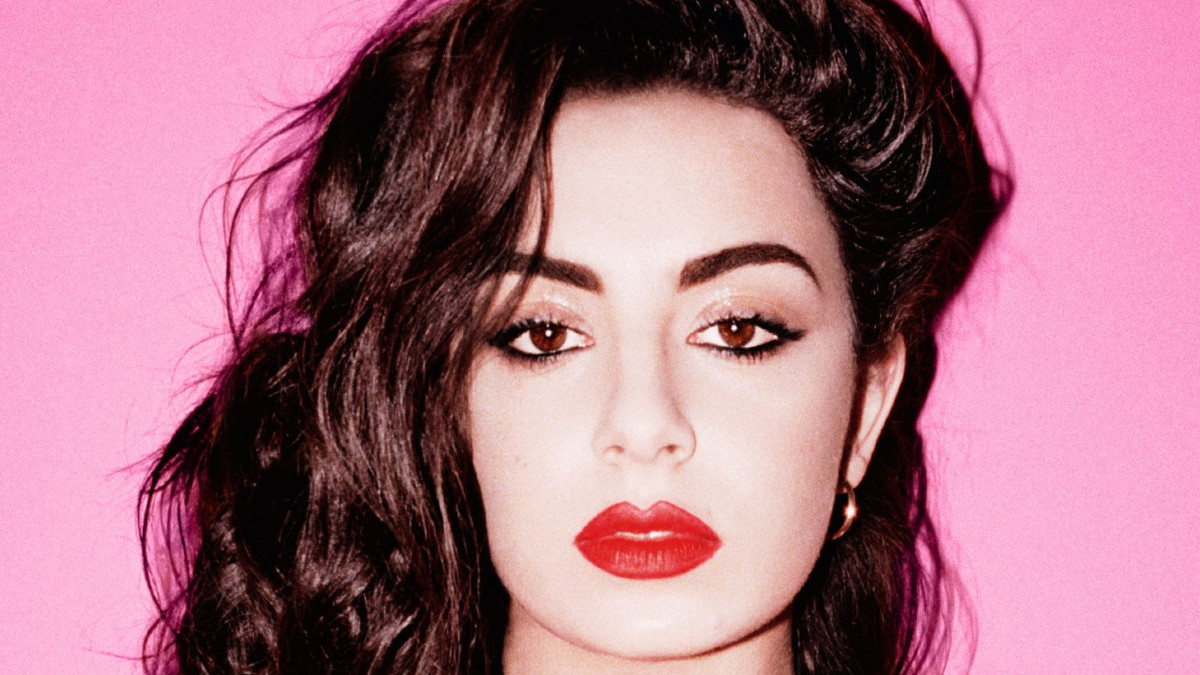 Charli XCX pictured for her 'Sucker' album artwork with a pink background