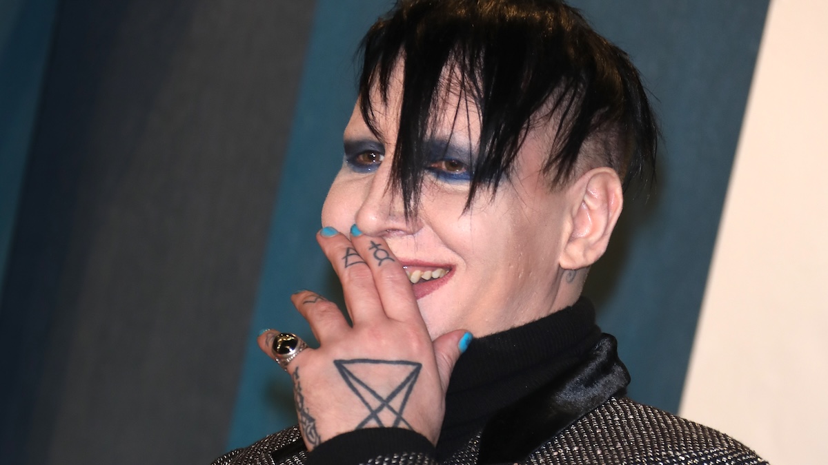 Marilyn Manson seen with his tattooed hand over his mouth, smiling while attending the 2020 Vanity Fair Oscar Party at Wallis Annenberg Center for the Performing Arts