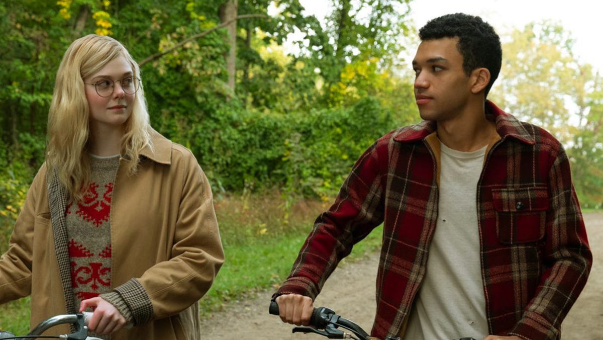 L-R: Violet Markey (Elle Fanning) and Theodore Finch (Justice Smith) walking side-by-side while holding their bikes