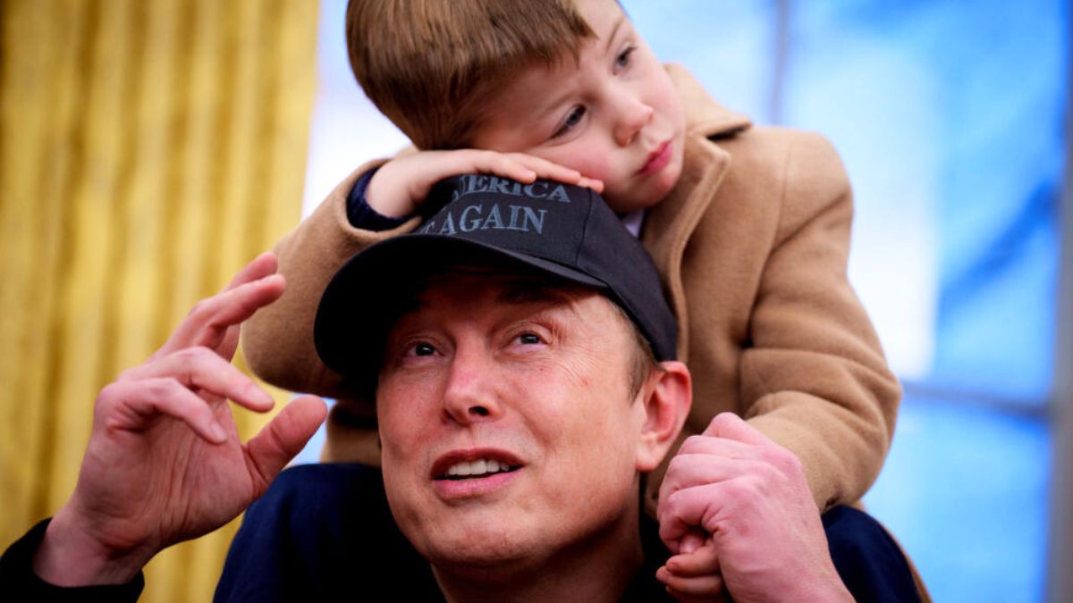 WASHINGTON, DC - FEBRUARY 11: X Musk sits on the shoulders of his father, Tesla and SpaceX CEO Elon Musk, as they join U.S. President Donald Trump for an executive order signing in the Oval Office at the White House on February 11, 2025 in Washington, DC. Trump is to sign an executive order implementing the Department of Government Efficiency's (DOGE) "workforce optimization initiative," which, according to Trump, will encourage agencies to limit hiring and reduce the size of the federal government. (Photo by Andrew Harnik/Getty Images)