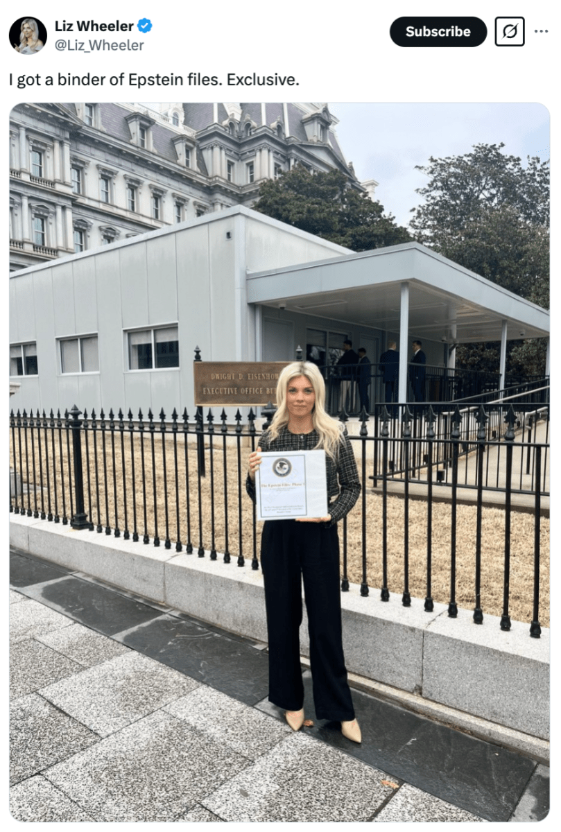 Liz Wheeler holding a Jeffrey Epstein binder