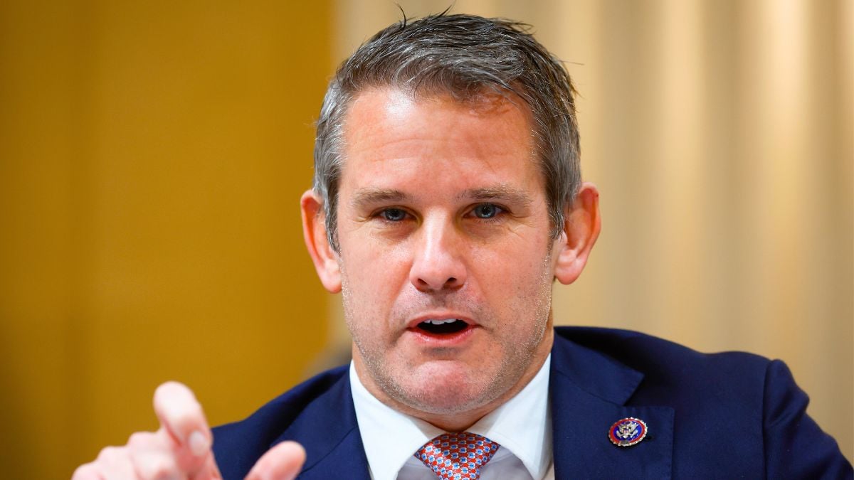 adam kinzinger pointing at a desk
