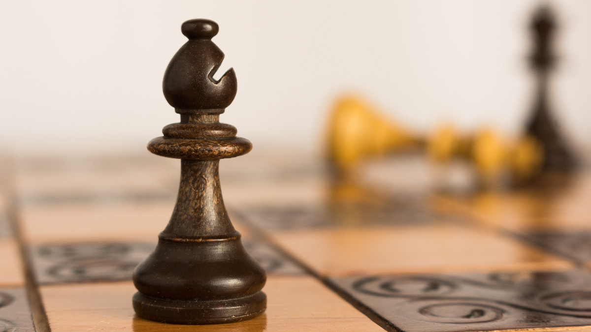 A bishop chess piece photographed on a chess board