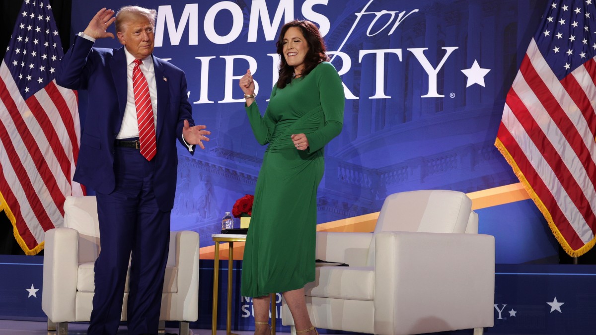 Donald Trump and Moms for Liberty's Tiffany Justice dance during the Joyful Warriors National Summit
