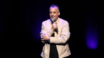 joe gatto with a microphone doing stand up