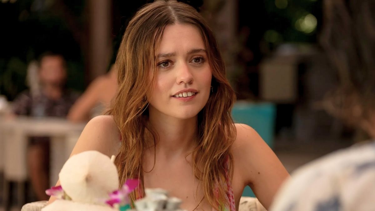 Aimee lou wood smiling at a table