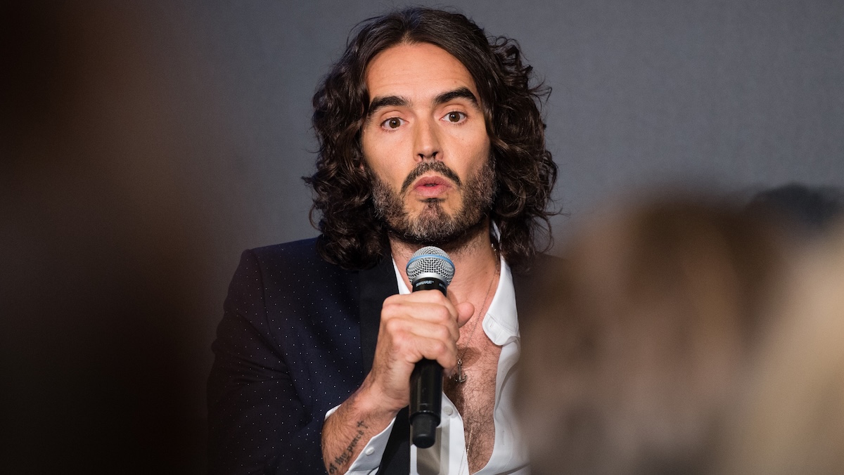 russell brand with a mic