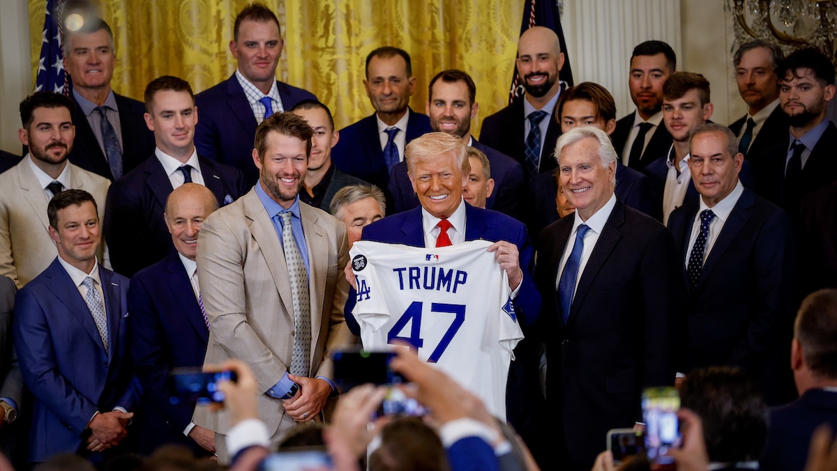 donald trump holding up a baseball jersey
