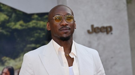 mahershala ali standing on a carpet