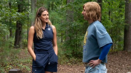 two people standing in the woods