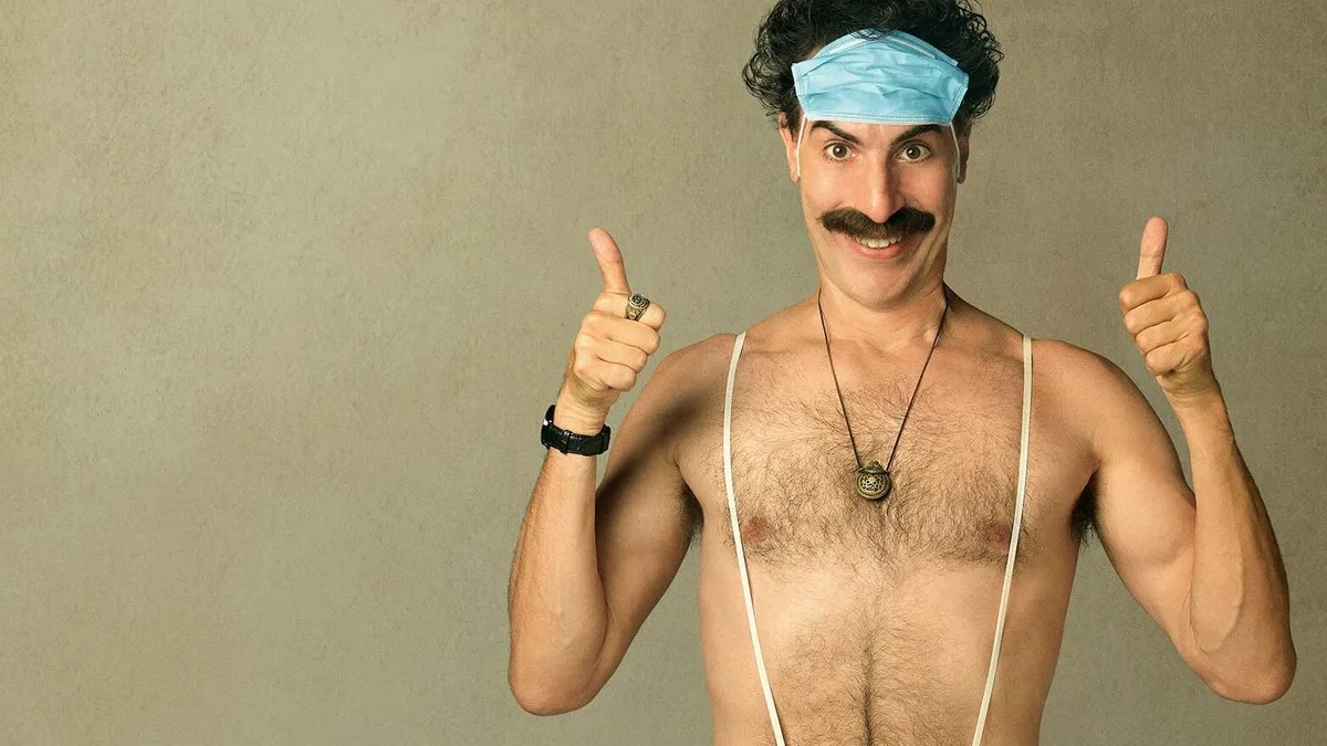 A shirtless man gives two thumbs up in "Borat"