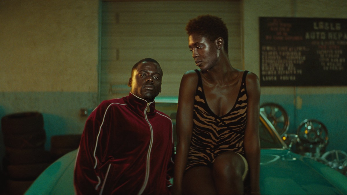 A couple lean on a car in "Queen and Slim" 