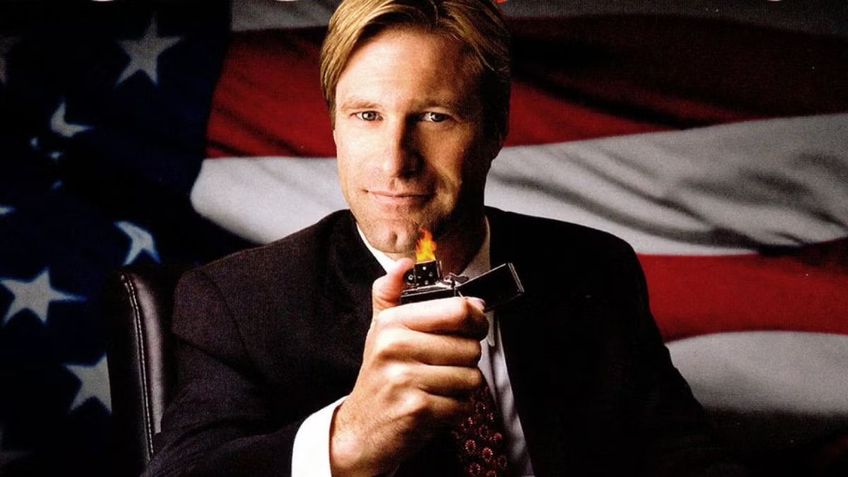 A man holds a lighter in front of an American flag in "Thank You For Smoking"