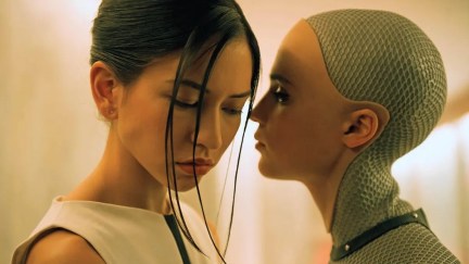 An android woman leans up close to another in 