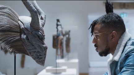 killmonger looking at a mask