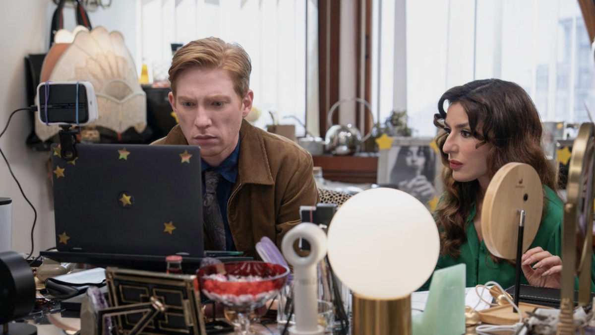 two people sitting at a computer